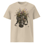 A beige crewneck t-shirt featuring a Wry Bird graphic print of a dark metal gas mask filled with an assortment of colorful wildflowers, shown against a plain white background.