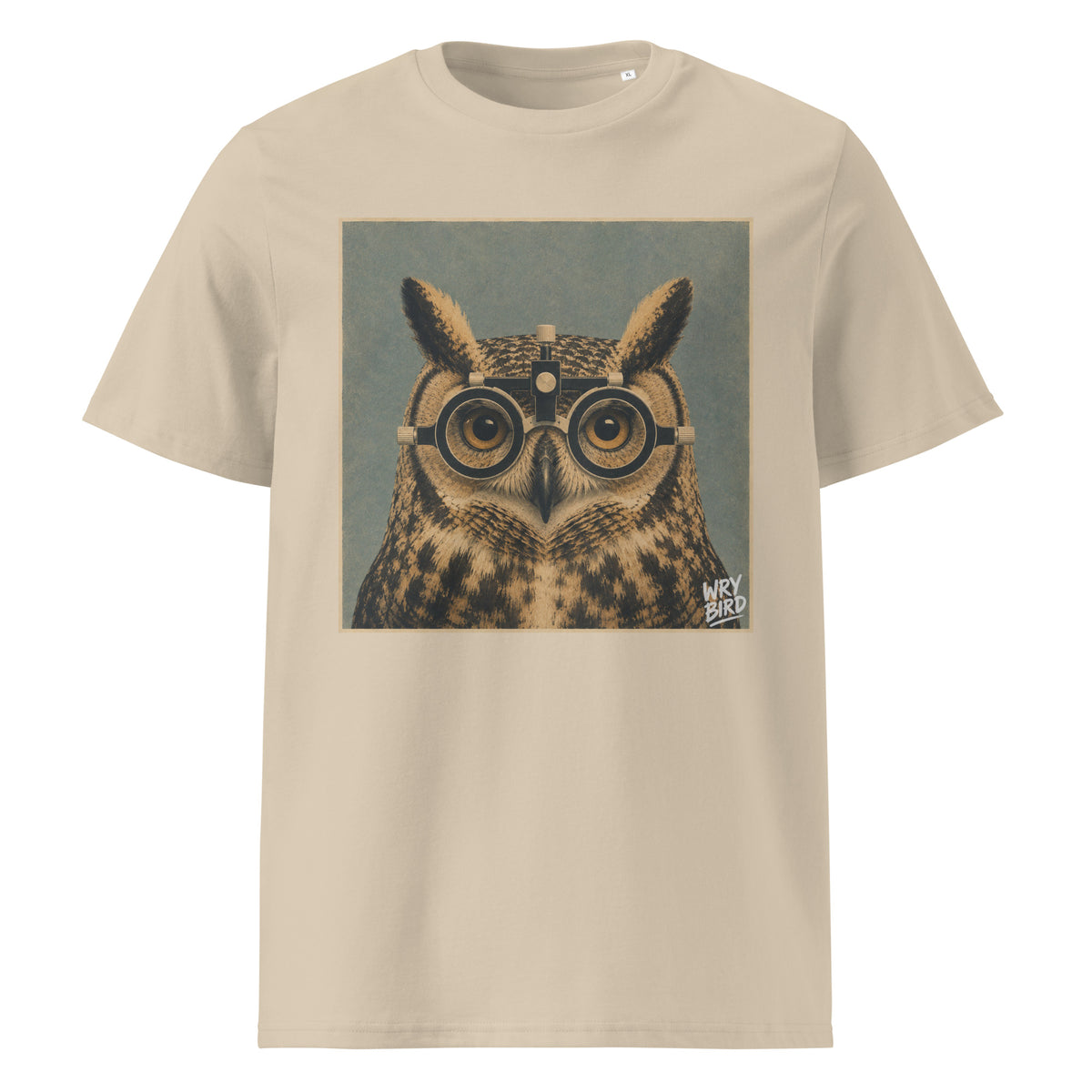 A beige short-sleeve Wry Bird crewneck t-shirt featuring a square graphic print of an owl wearing eye test glasses, set against a muted blue-gray background. 