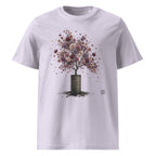 A light lavender crewneck t-shirt featuring a graphic Wry Bird print of a tree with a dark brown barrel trunk and a canopy of colorful, flower-like blossoms in shades of pink, purple, and red.