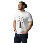 A man wearing a white crewneck t-shirt with a graphic of an old bomb with colorful butterflies, paired with dark blue jeans, against a plain white background.