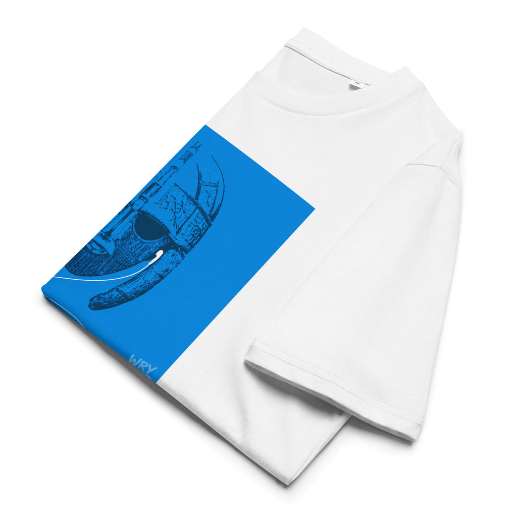 A white short-sleeve t-shirt folded flat, featuring a large bright blue Saxon graphic panel on the front with a dark blue illustration and the words 'Wry Bird' printed near the bottom.